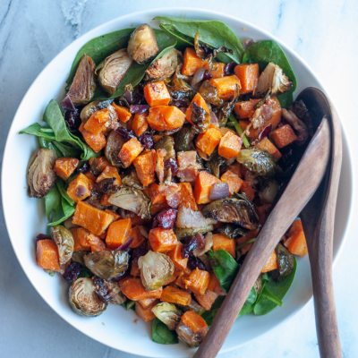 maple bacon brussels sprout salad with wooden spoons