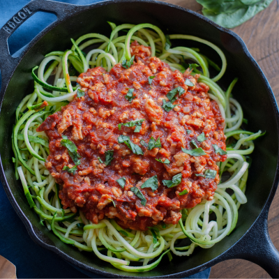 zucchini noodles with red sauce in a skillet