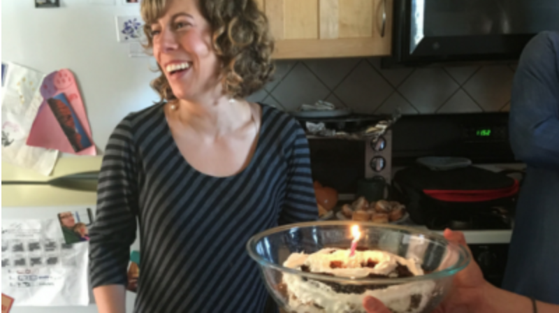 women with cake in front of her