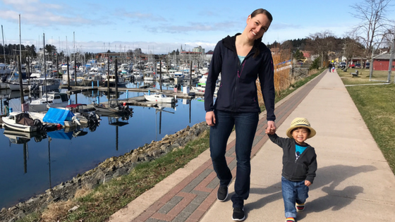 mother and son holding hands outside