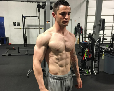 ripped male body building athlete standing in the gym